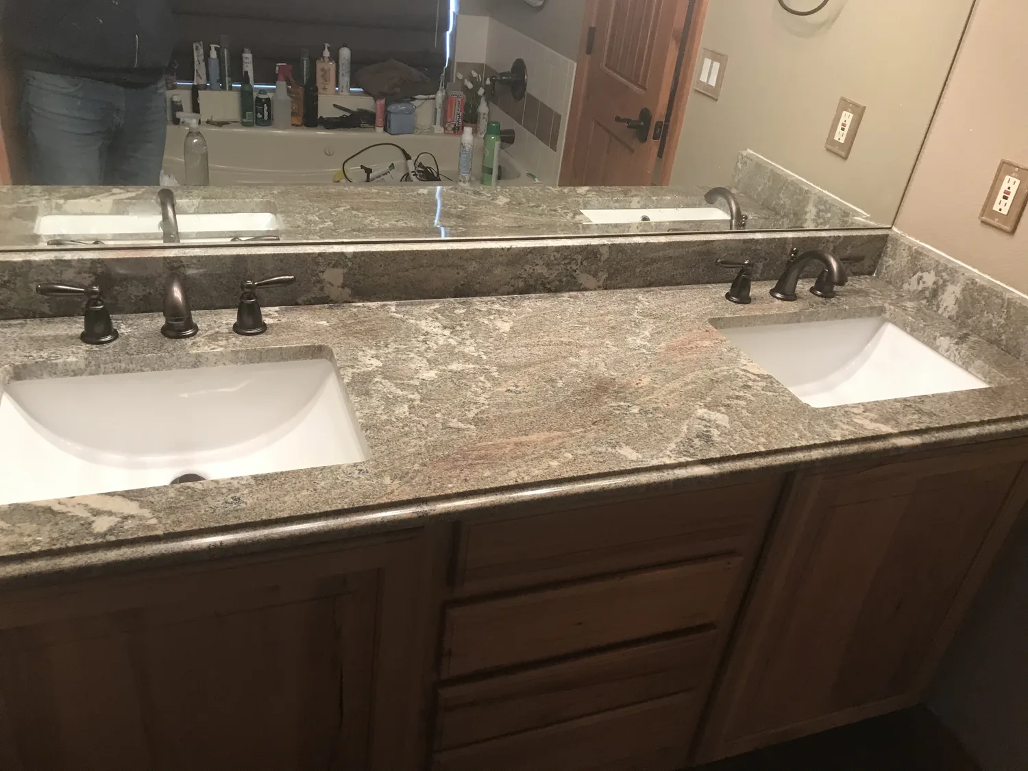 Dark bathroom vanity with stone counter and sink