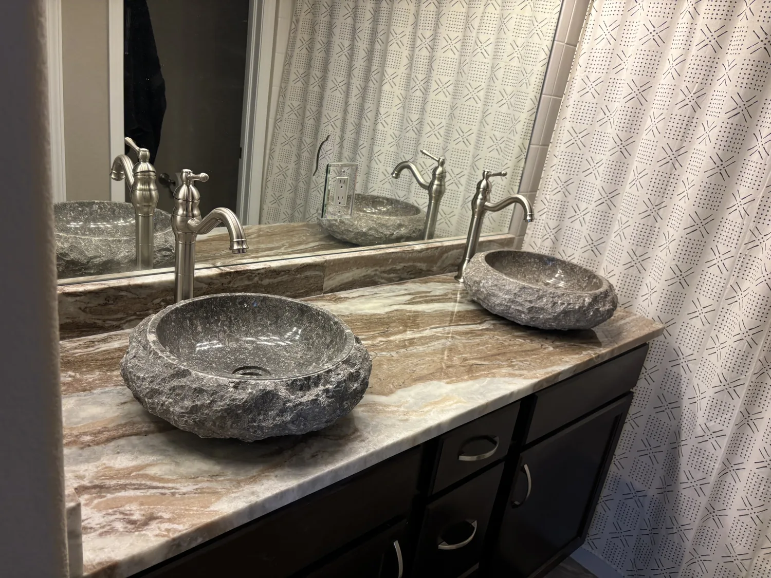 Double bathroom vanity with stone countertop and vessel sinks