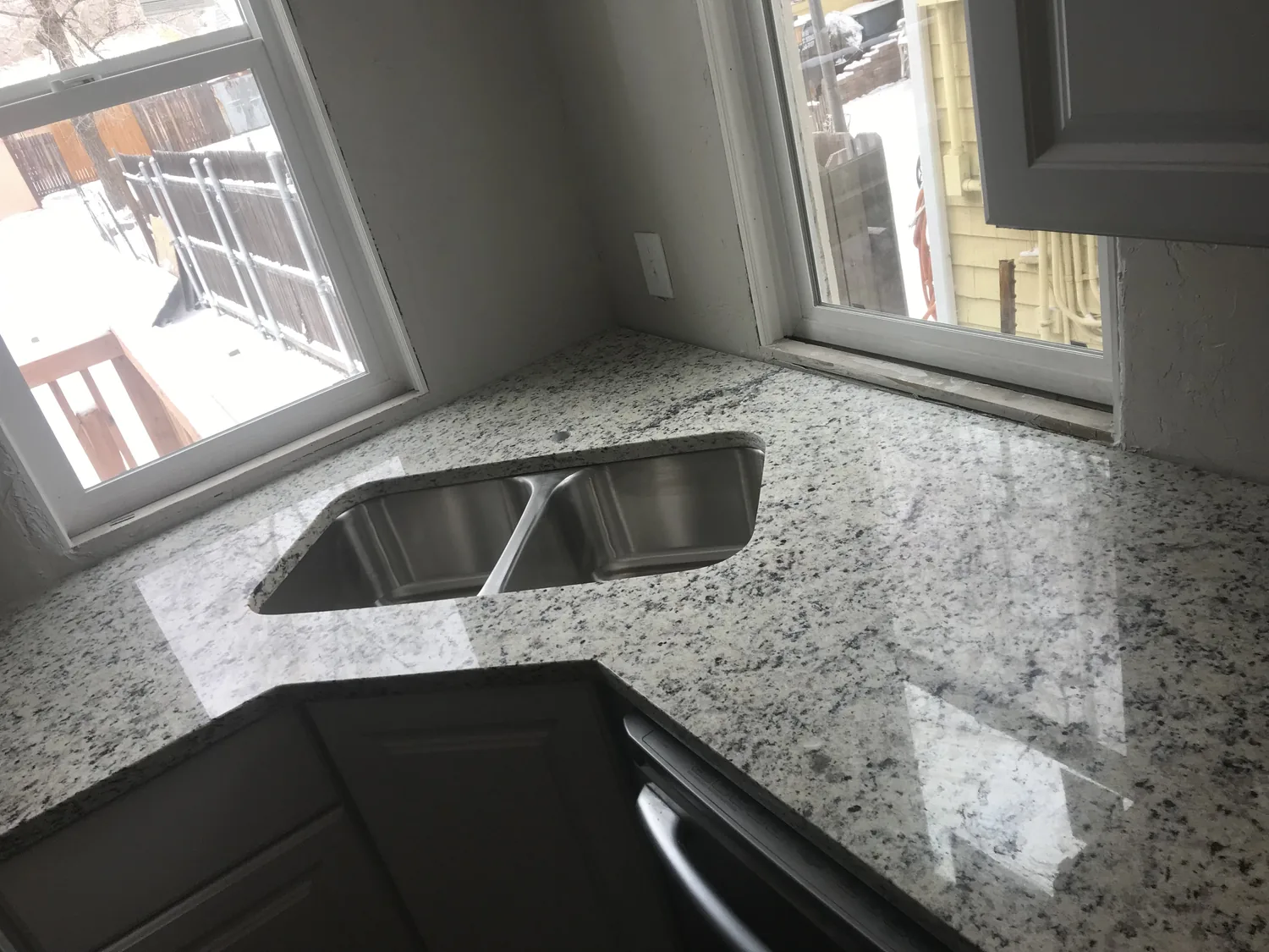 Corner sink with stone countertop in a kitchen