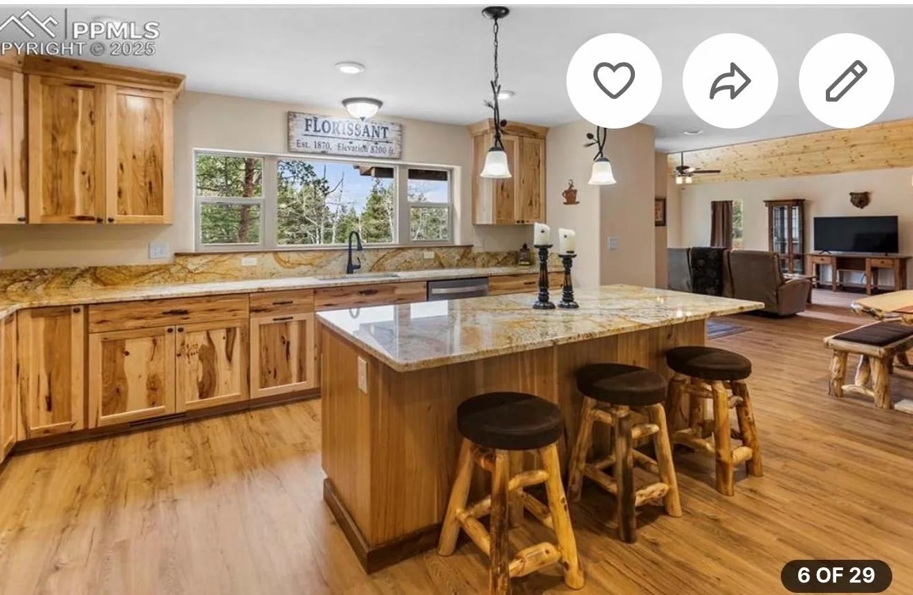 Rustic kitchen with finished stone island, wood cabinets, and backsplash work