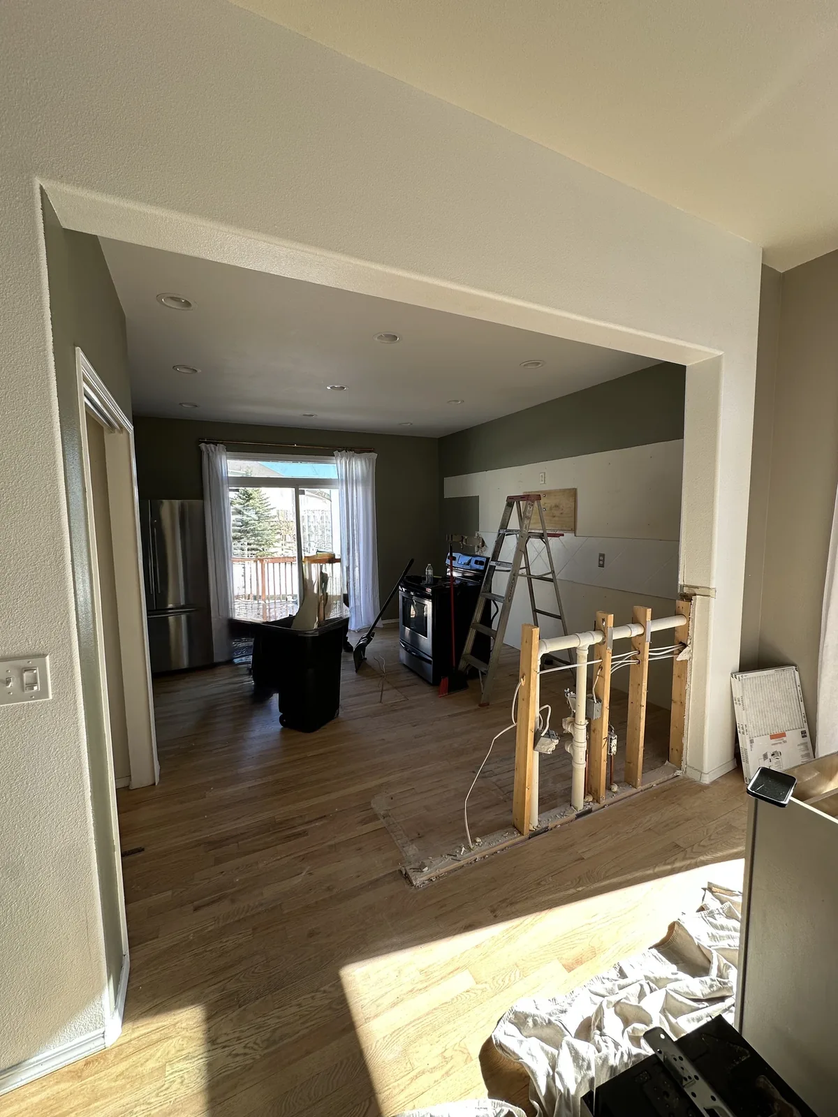 Kitchen remodel before wall and island work with open room visible