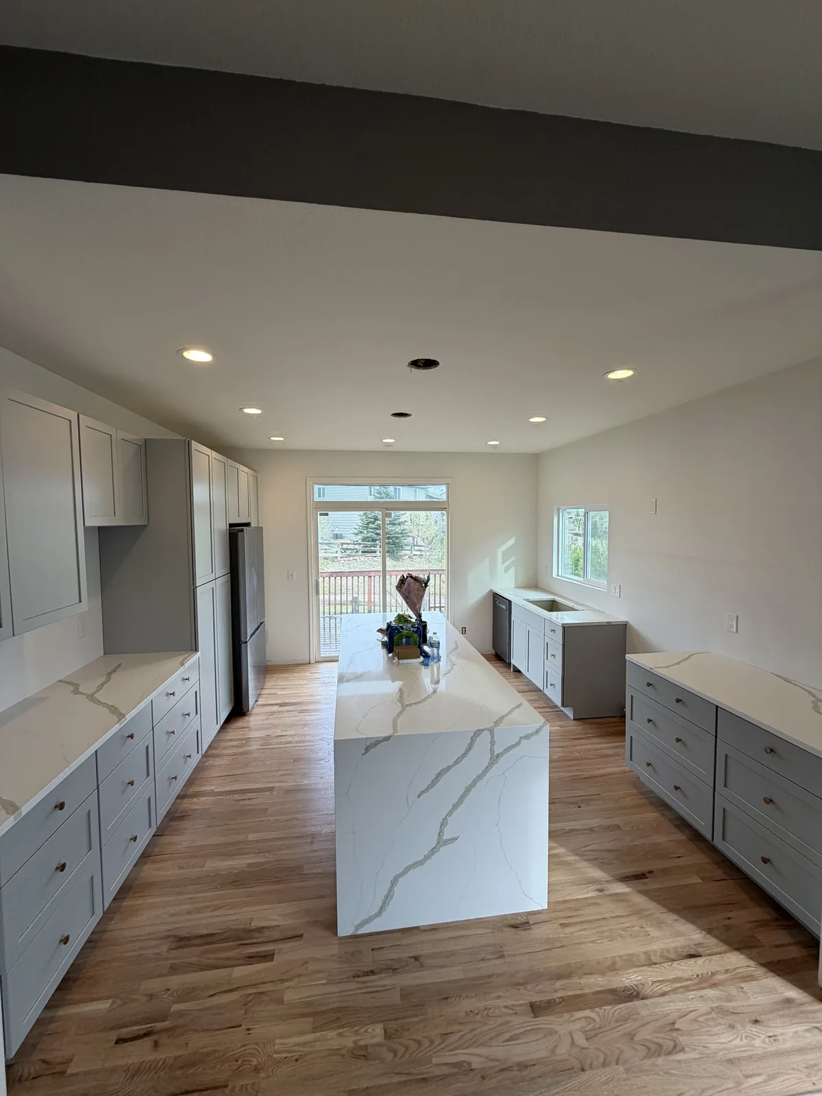 Finished kitchen remodel with double waterfall island and bright open layout