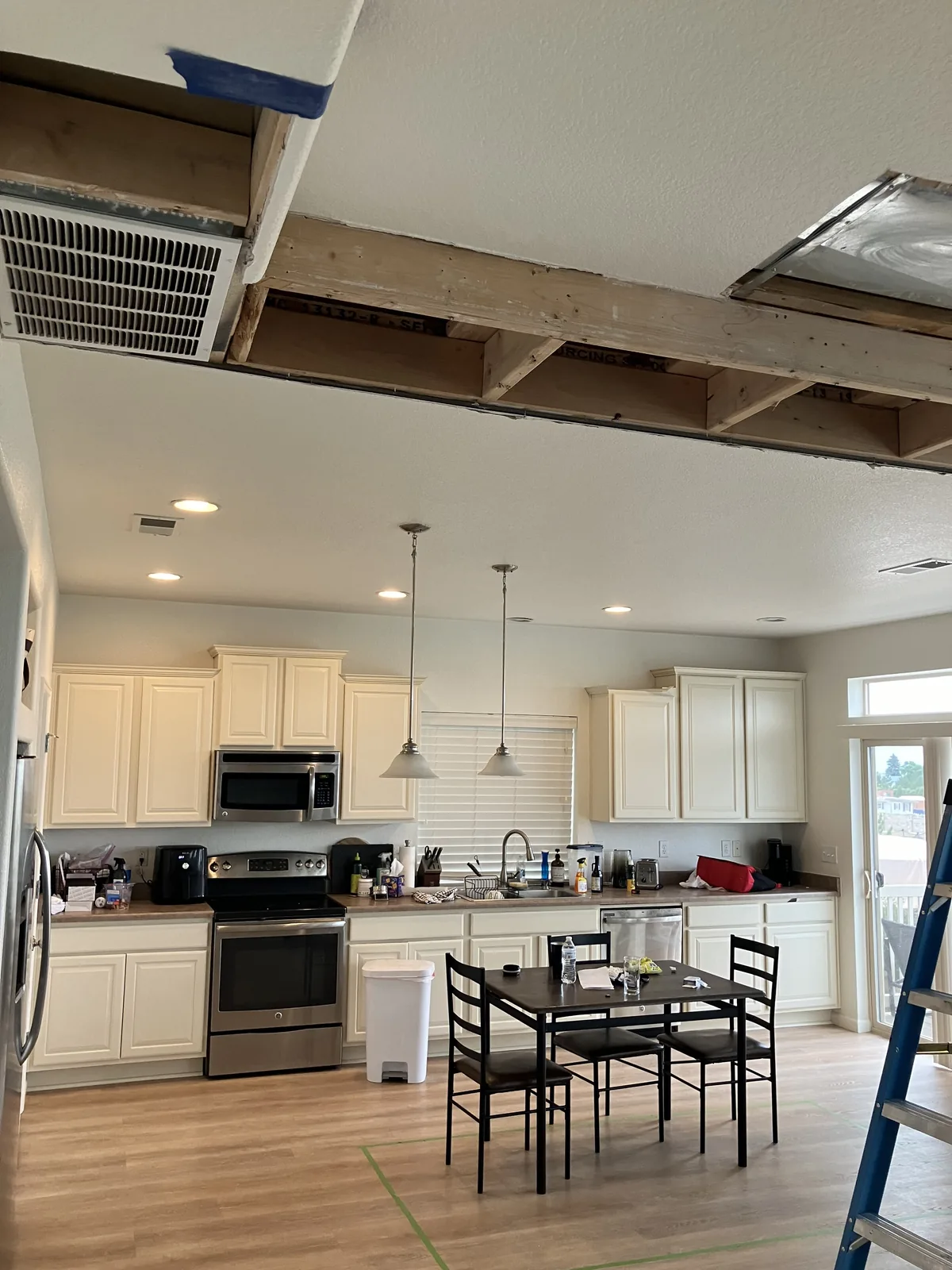 Kitchen remodel in progress with ceiling opened above the work area
