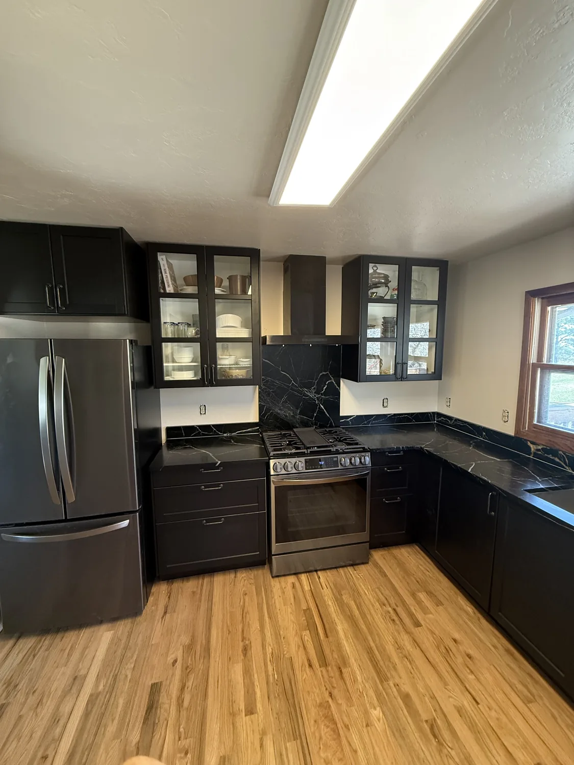 Kitchen with dark cabinets before a lighter remodel finish