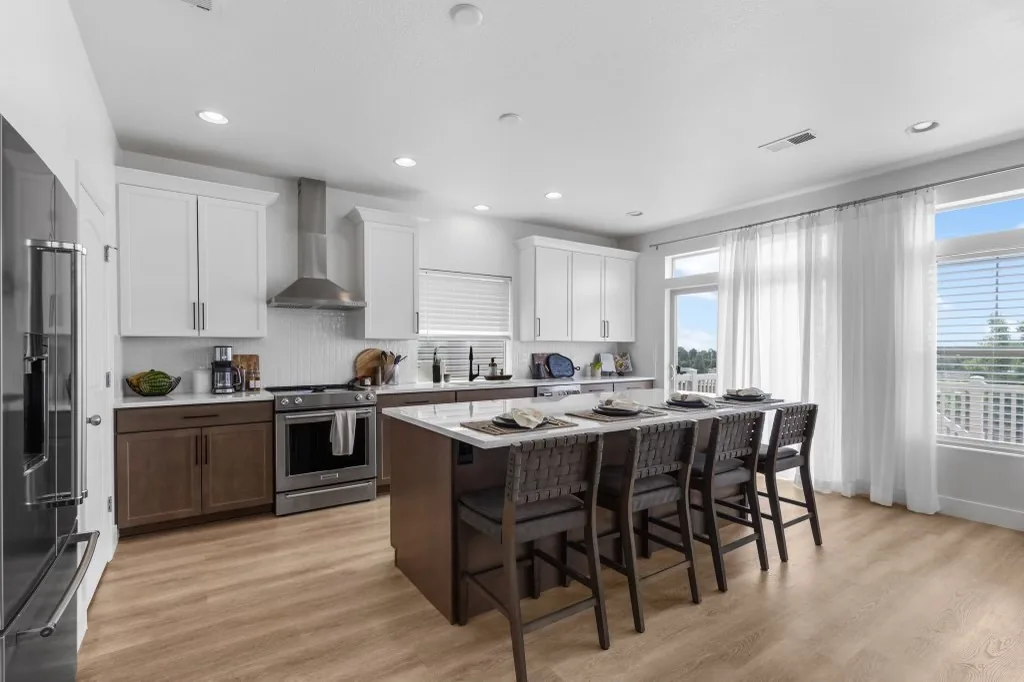 Wide finished kitchen remodel with island seating and bright windows