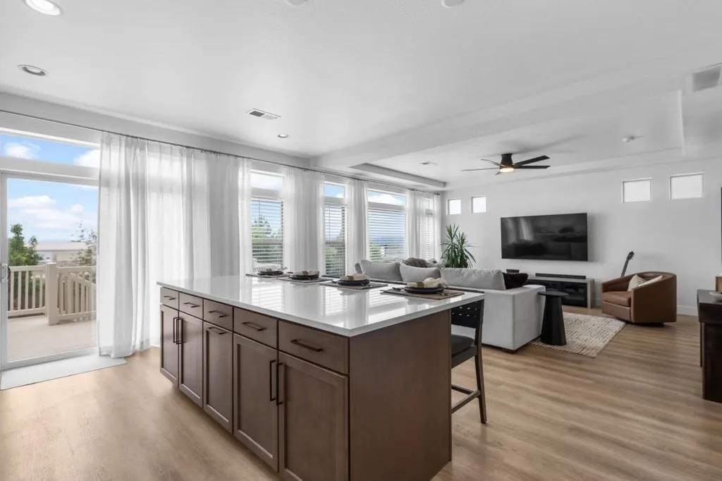 Finished open kitchen remodel with island, dining seating, and living area