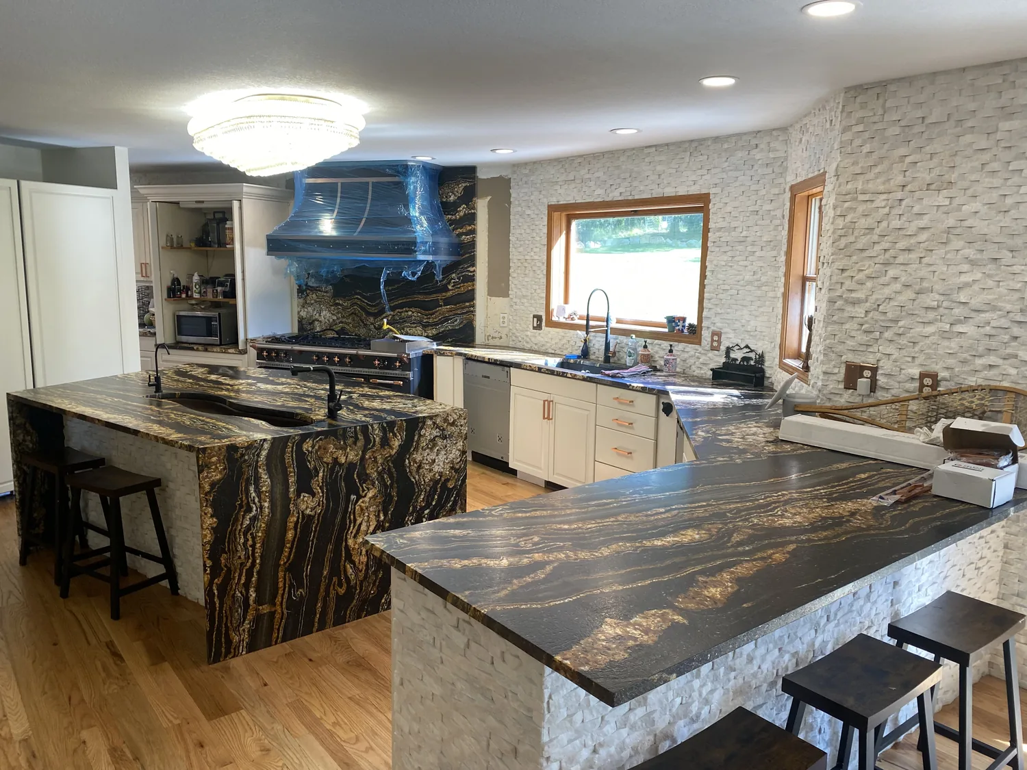 Kitchen with multiple finished stone work surfaces