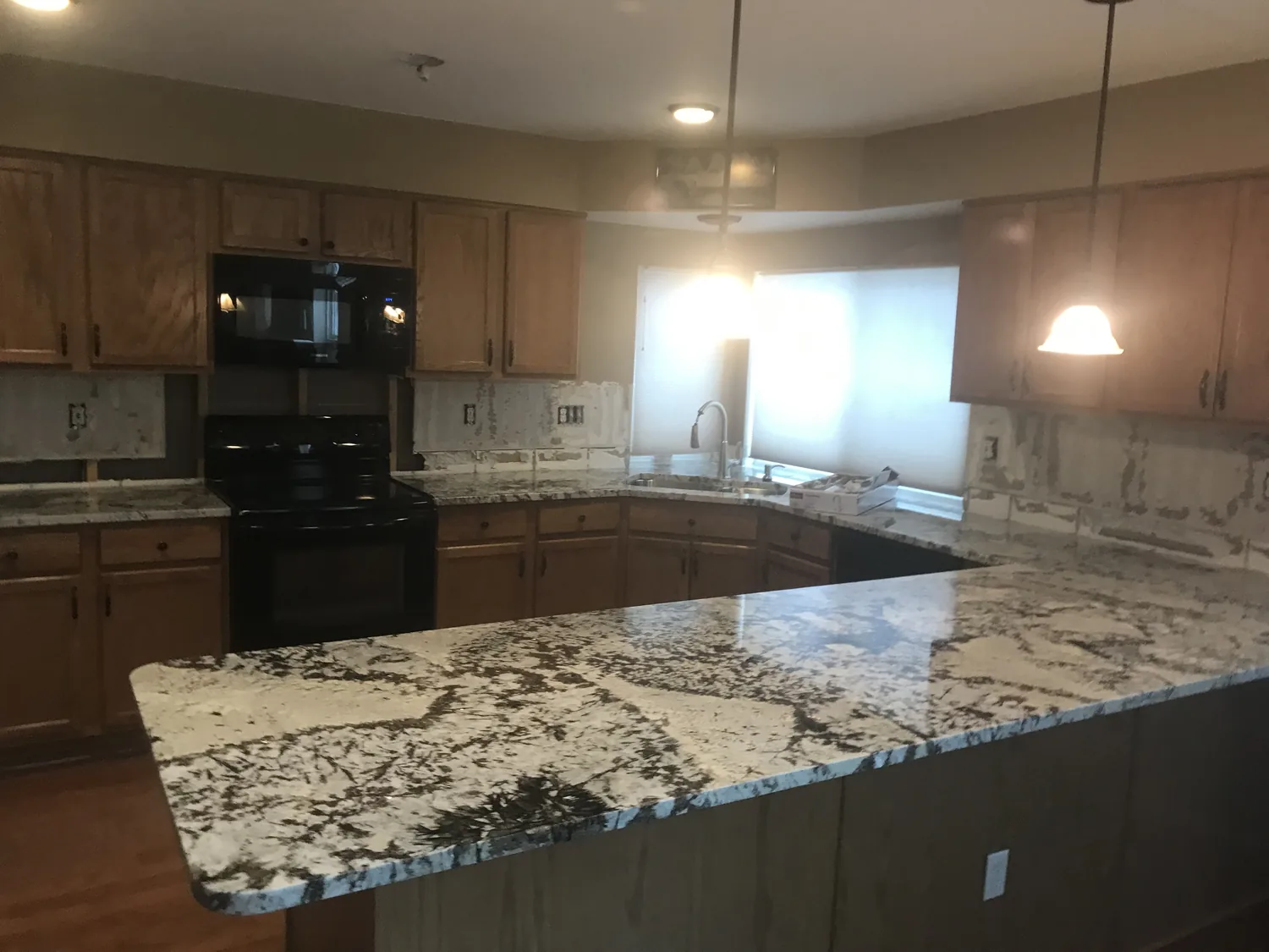 Large finished granite island in a kitchen
