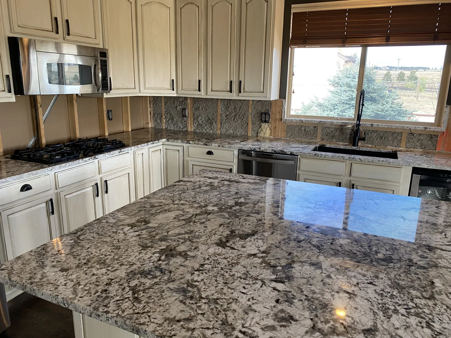 Polished granite island surface with bright reflection