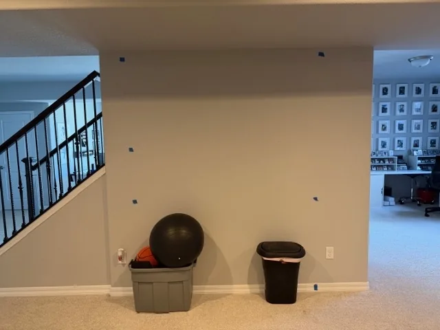 Before photo of an open wall area marked for remodel work