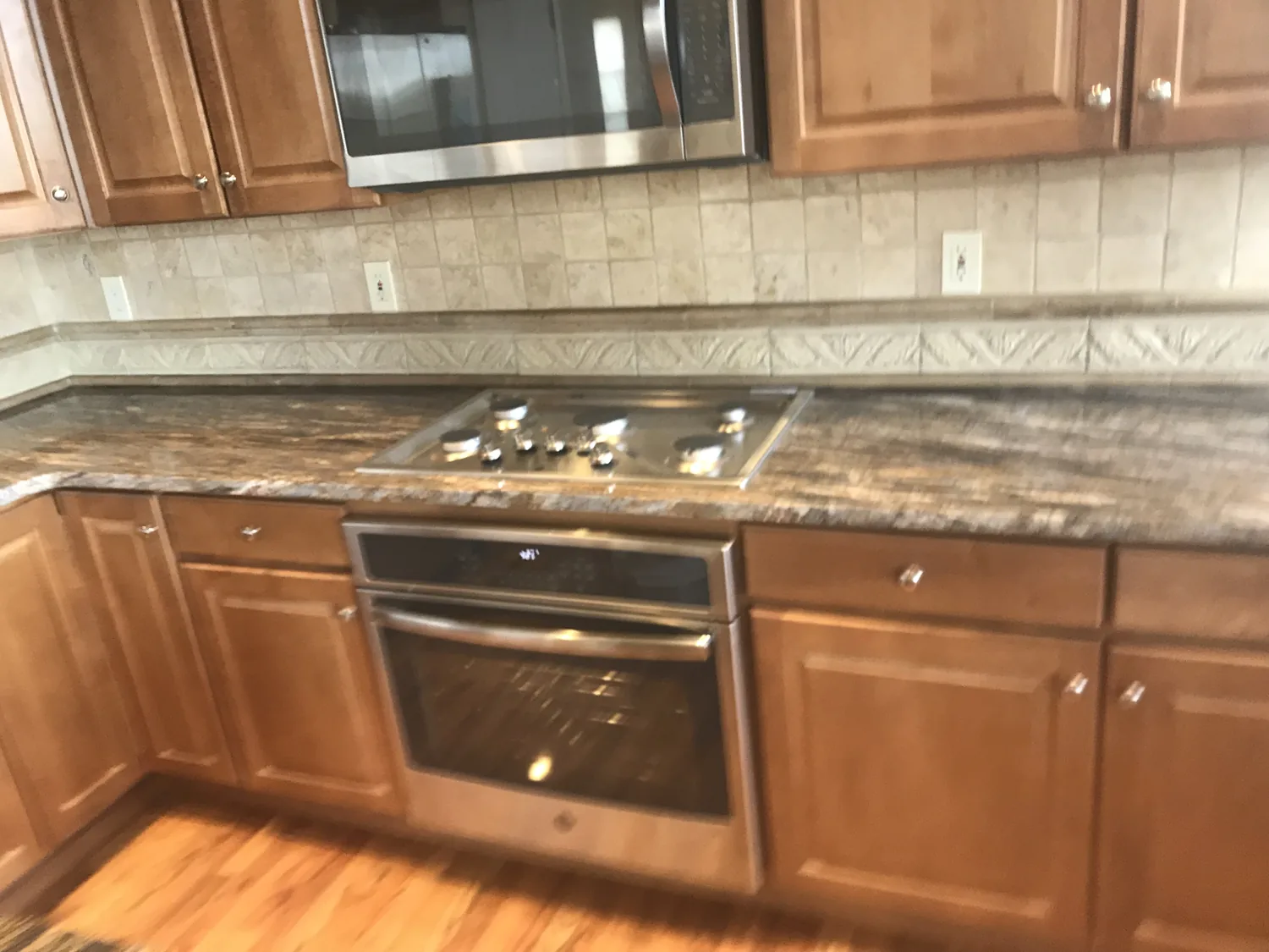 Stone counters around a kitchen range wall